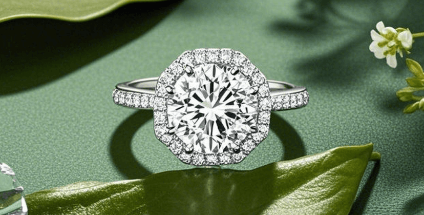 A diamond ring with a large center stone on a green leaf